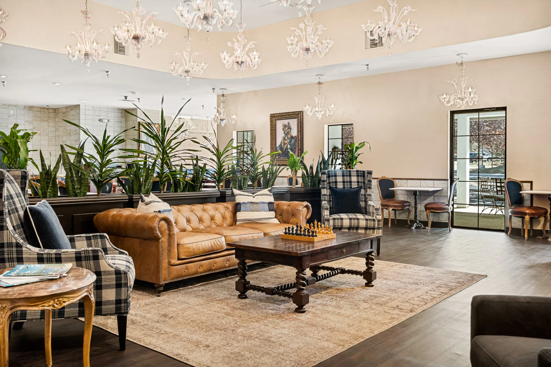 lounge area with leather sofa, armchairs, coffee table with chess board